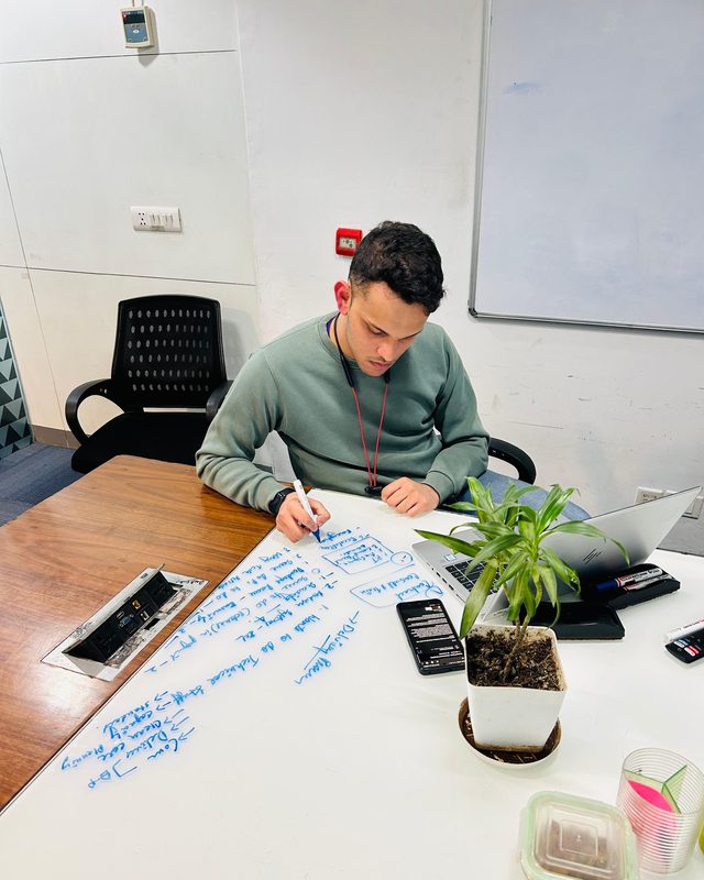 Writing a delivery plan out on a whiteboard table