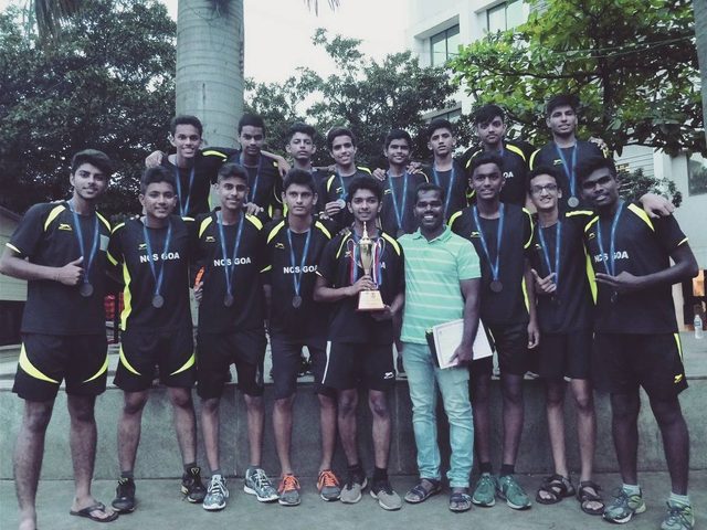 The school football team with its medals and trophy
